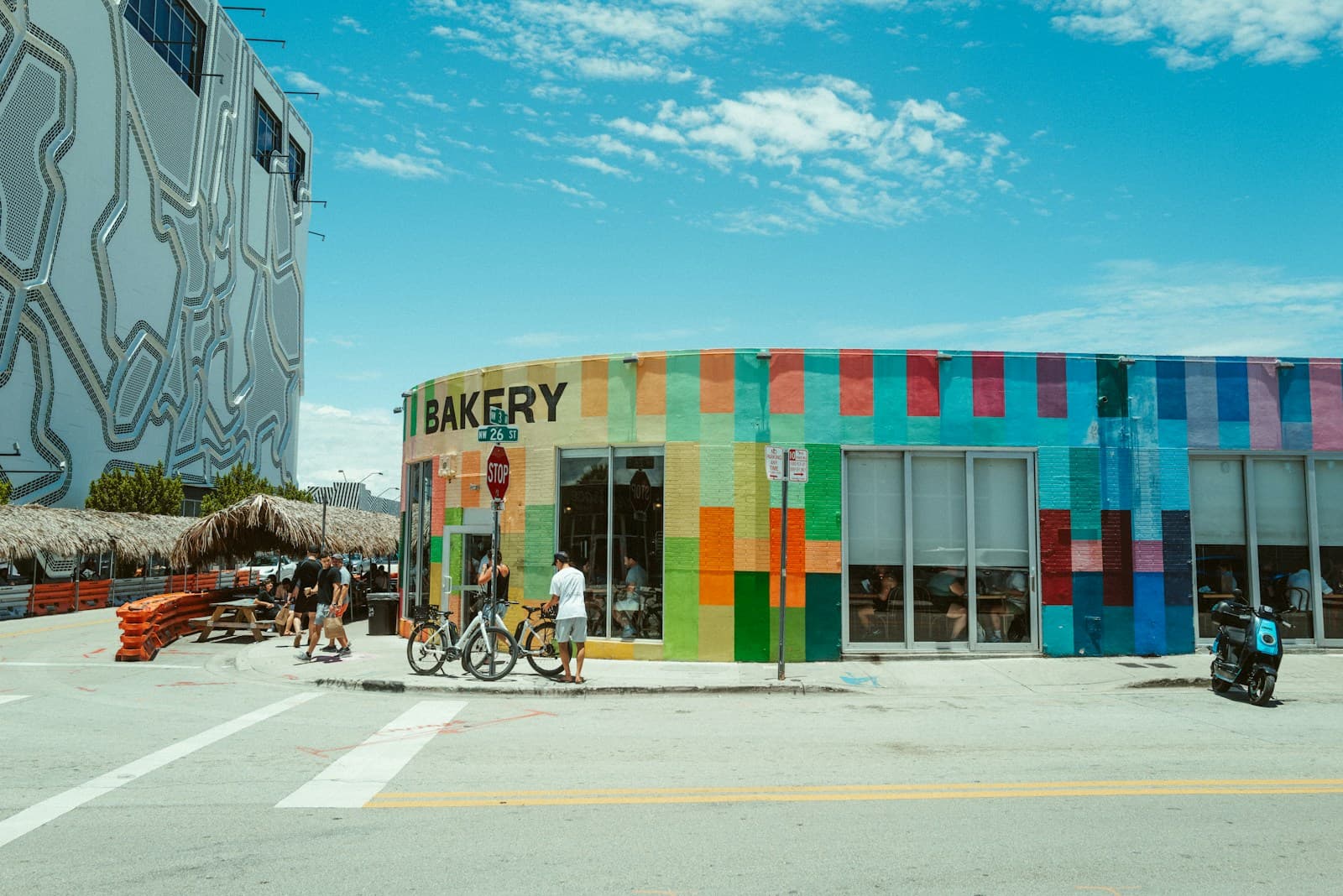Colorful mural-covered building with people outside in Wynwood, Miami
